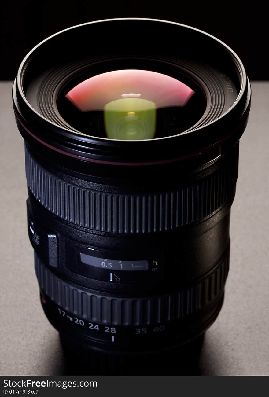 Camera lens on black background with reflection on the glass. Camera lens on black background with reflection on the glass