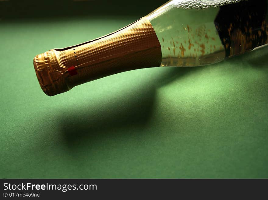 Bottle of white wine in green background