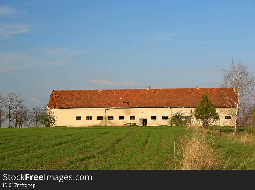 Old ruined farm over the cereal field is now empty. Old ruined farm over the cereal field is now empty.