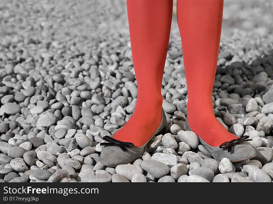 Two womens legs dressing in red tights. Two womens legs dressing in red tights