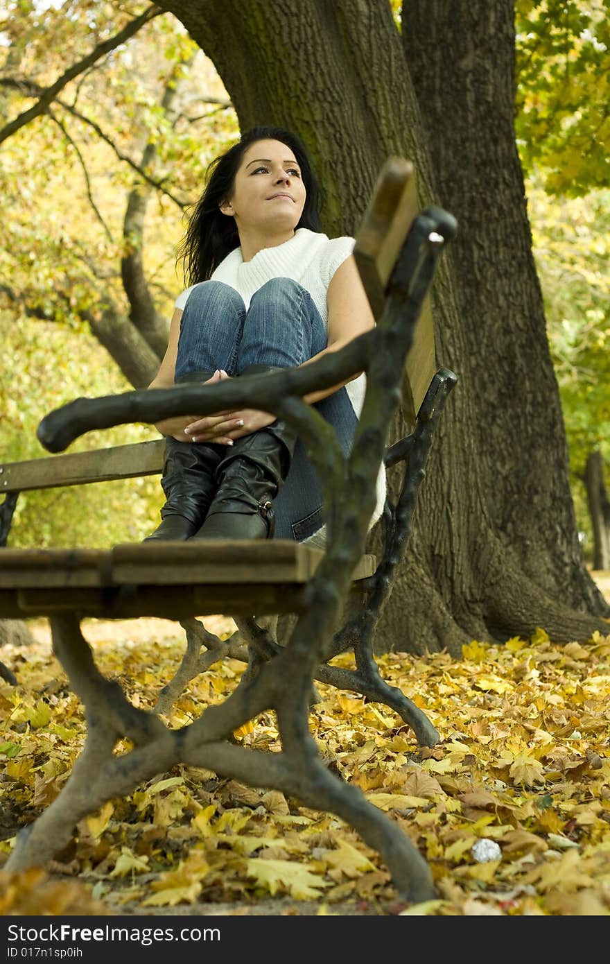 Woman sitiing in the park enjoying the indian summer. Woman sitiing in the park enjoying the indian summer