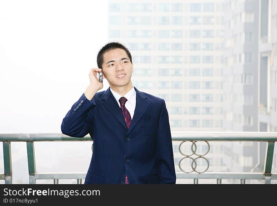 Young business man holding mobile phone