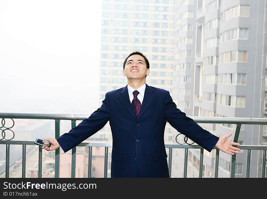 A young asian standing before building. A young asian standing before building