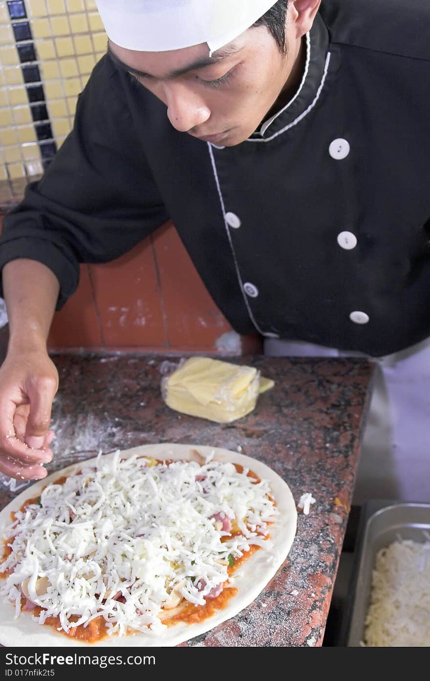 Chef cooking pizza in kitchen