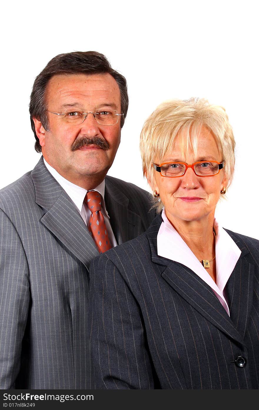 A senior business couple in suits in their 50s and 60s. Isolated over white. A senior business couple in suits in their 50s and 60s. Isolated over white.