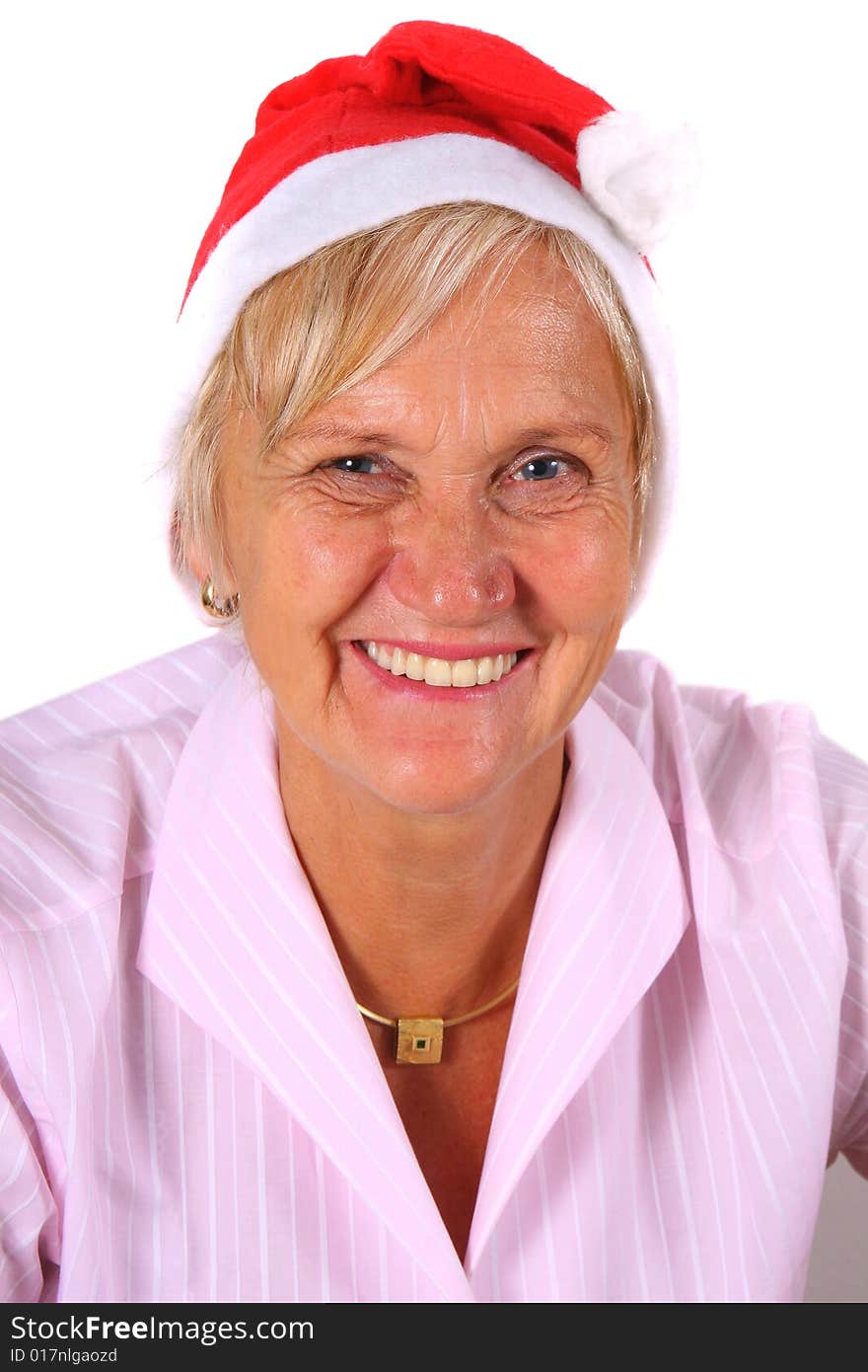 A businesswoman in her sixties with a Santa claus hat - smiling. Isolated over white. A businesswoman in her sixties with a Santa claus hat - smiling. Isolated over white.