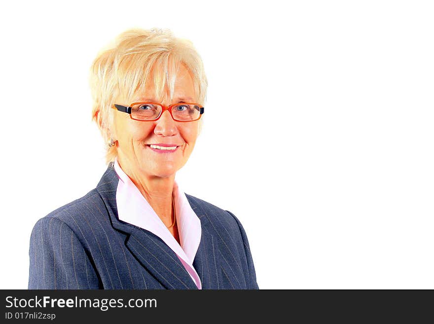 A businesswoman in her sixties with glasses and a suit. Isolated over white. A businesswoman in her sixties with glasses and a suit. Isolated over white.