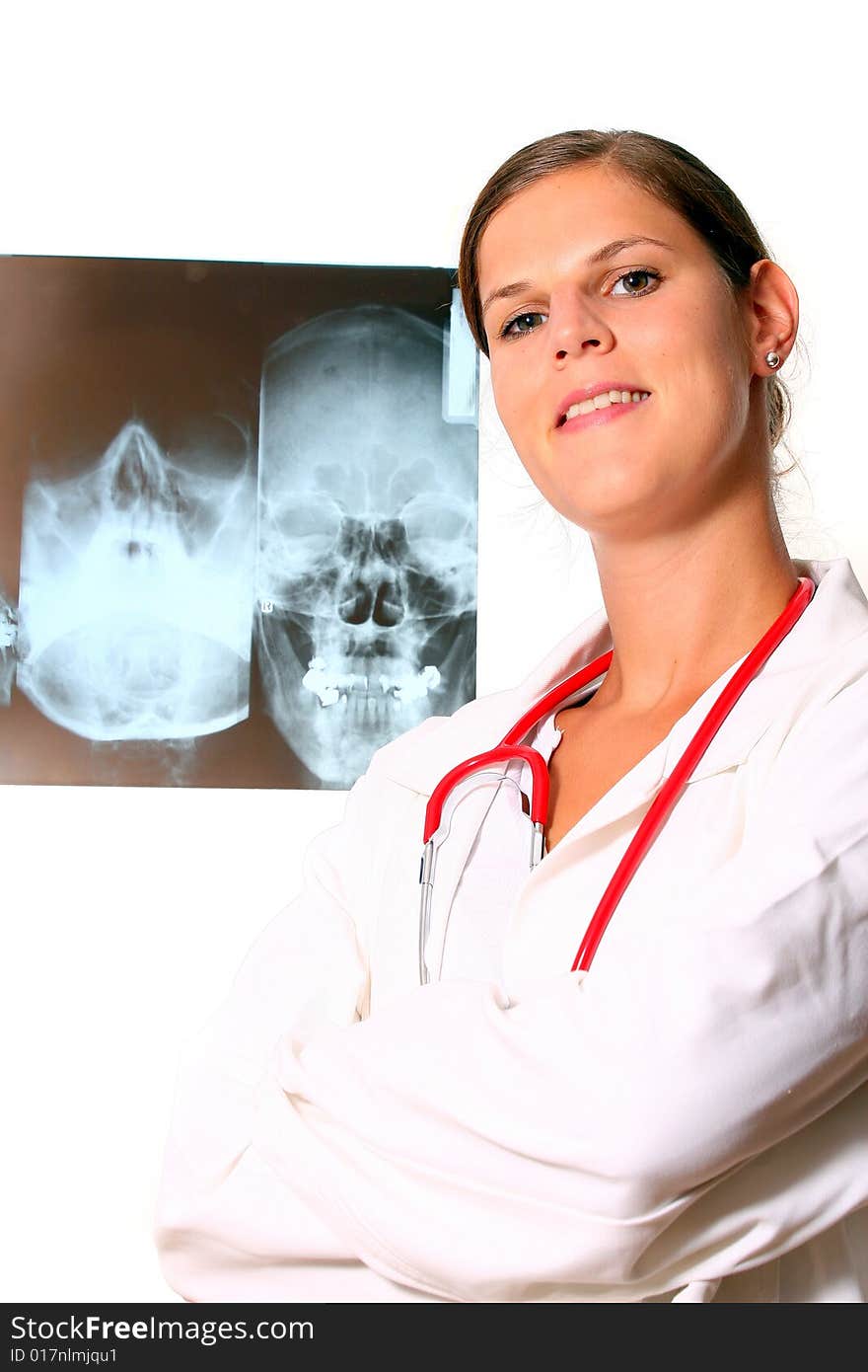 A beautiful young doctor with a red stethoscope and a xray image in the back. Isolated over white. A beautiful young doctor with a red stethoscope and a xray image in the back. Isolated over white.