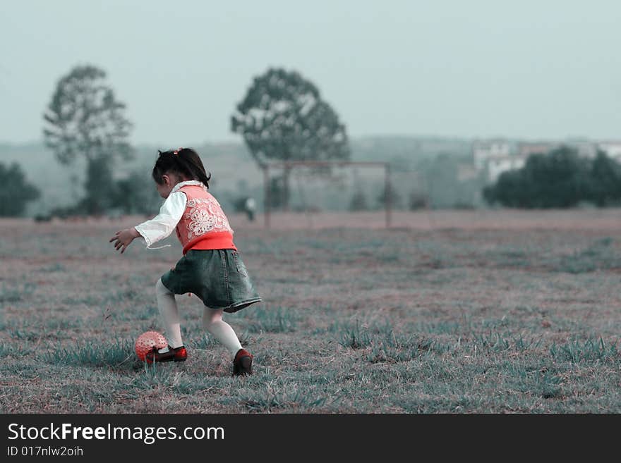 The girl playing ball outside.