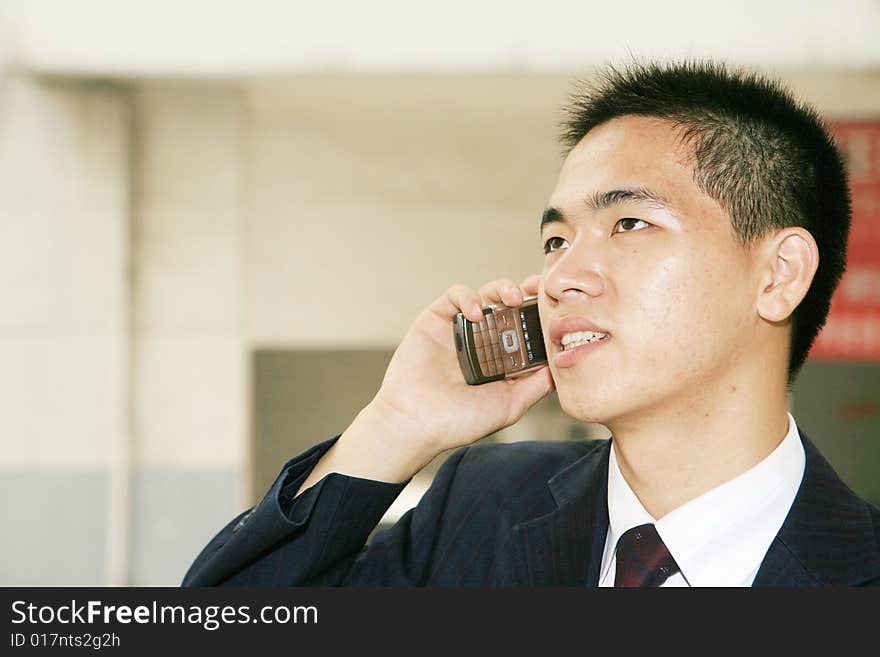 Young asian business man holding mobile phone