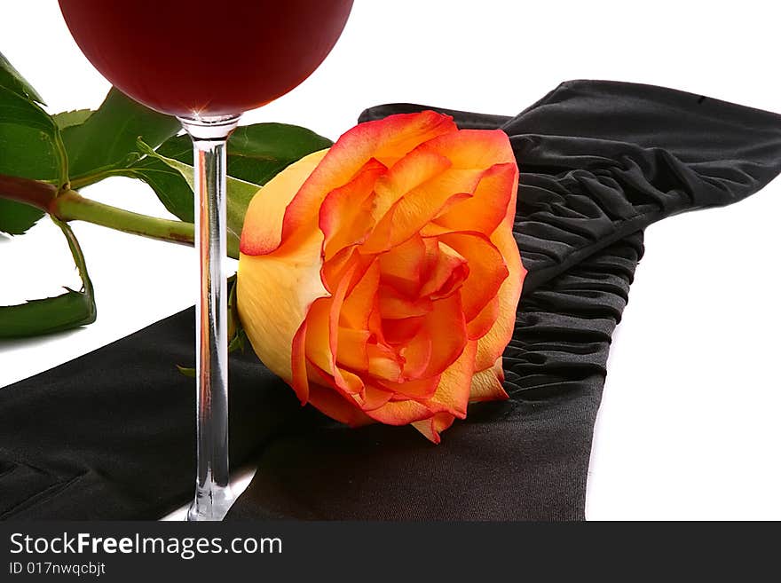 Composition from a glass of wine, female gloves and a rose flower