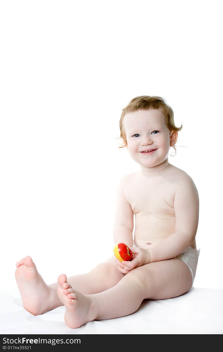 Cute caucasian child sits on a white table. Cute caucasian child sits on a white table