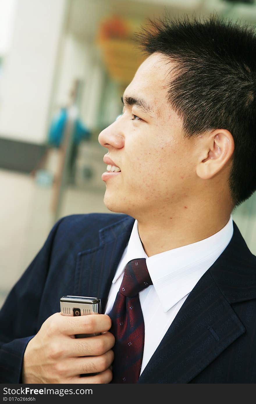 A young asian standing in office building. A young asian standing in office building