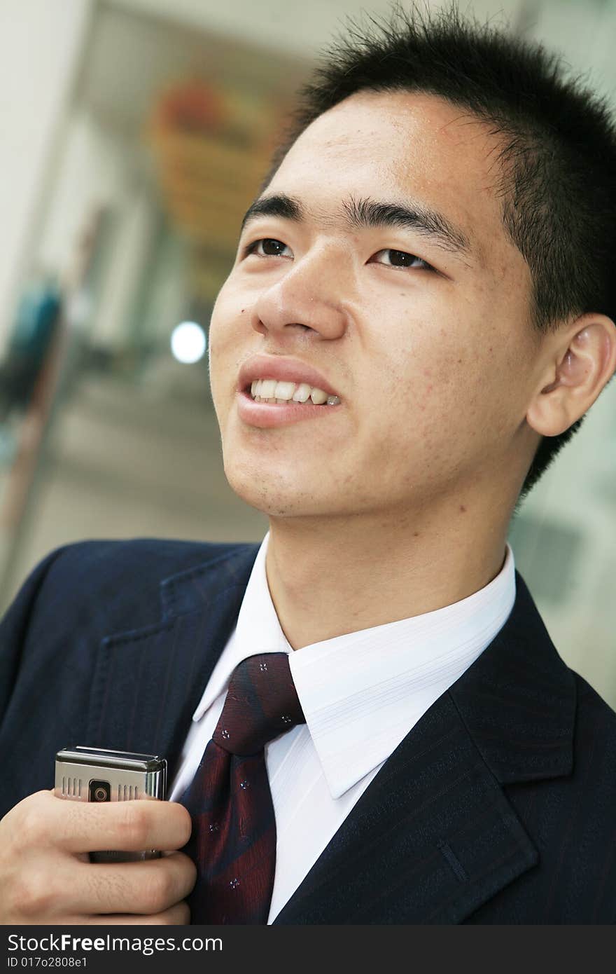 Young business man holding mobile phone