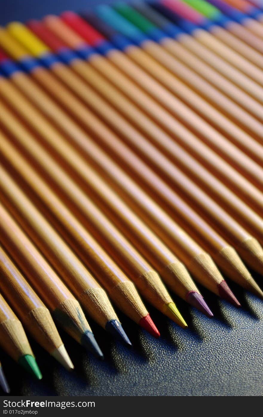 Colouring pencils laid out against a black surface. Colouring pencils laid out against a black surface.