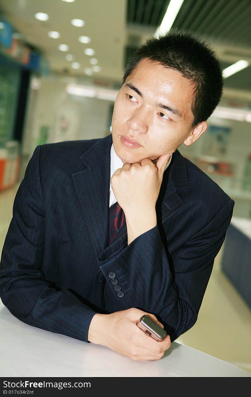 Young business man holding mobile phone