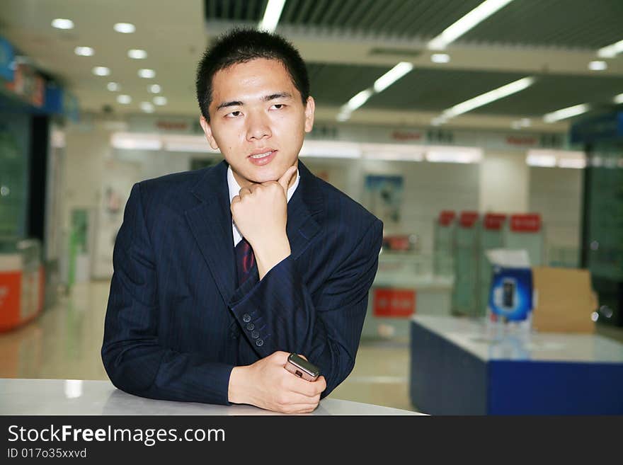 Young business man holding mobile phone