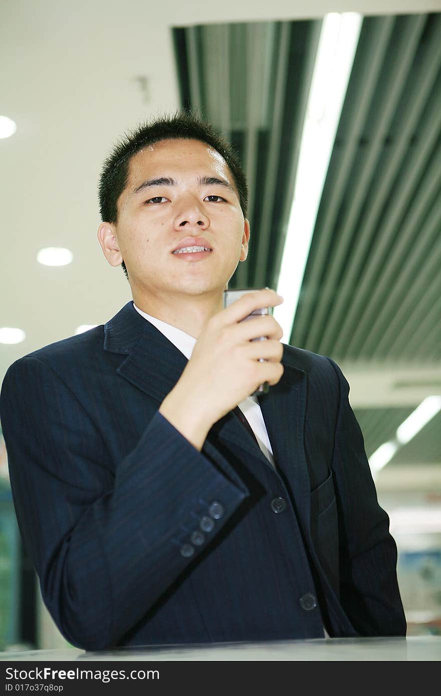 Young asian business man holding mobile phone