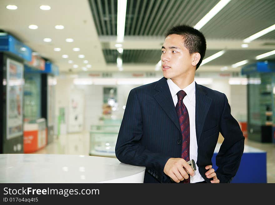 Young business man holding mobile phone