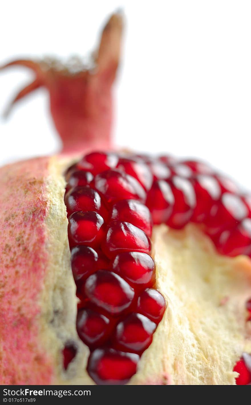 Peeled juicy pomegranate isolated over white background