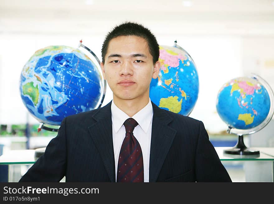 Young chinese business with tellurion. Young chinese business with tellurion