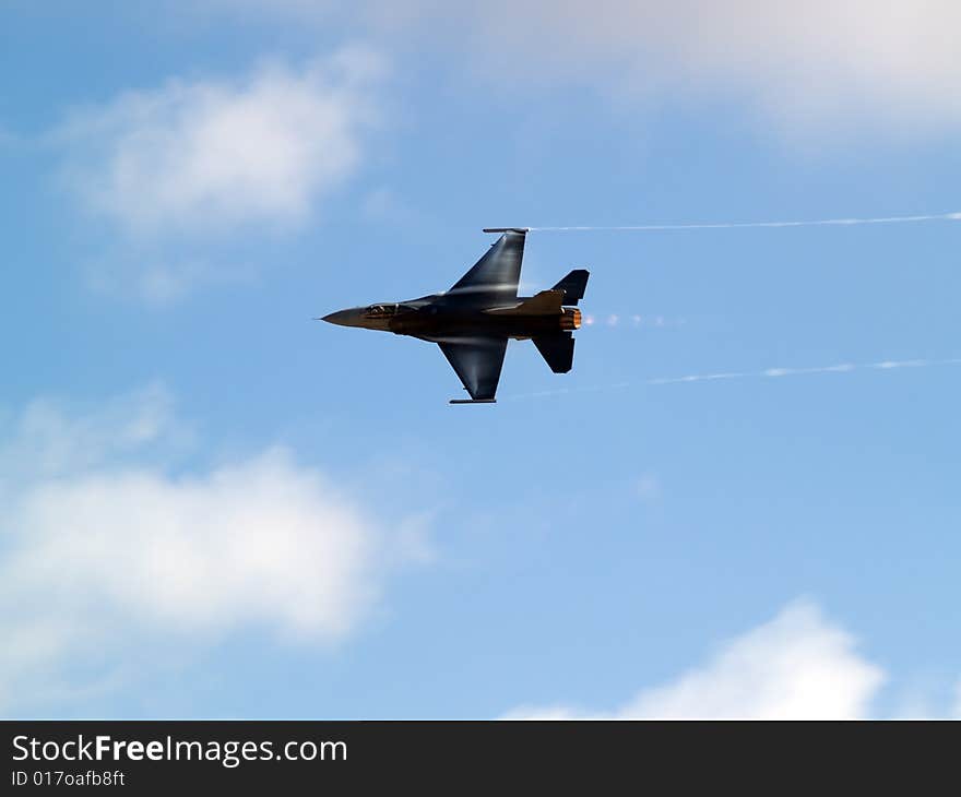 F-16 Fighting falcon turns with supersonic contrail. F-16 Fighting falcon turns with supersonic contrail