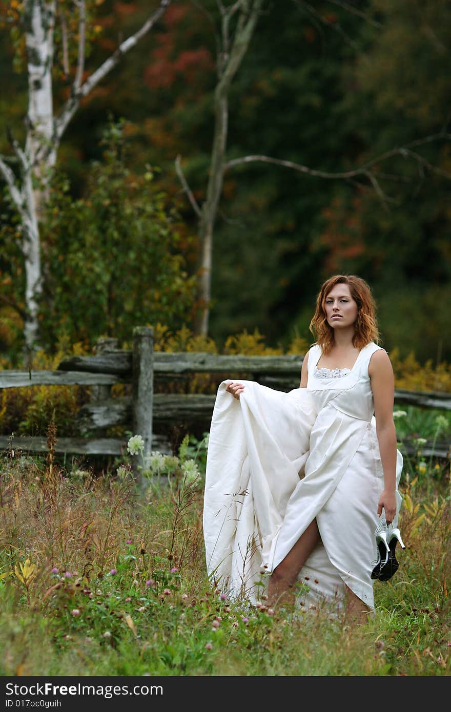 Female wearing wedding dress, natural setting