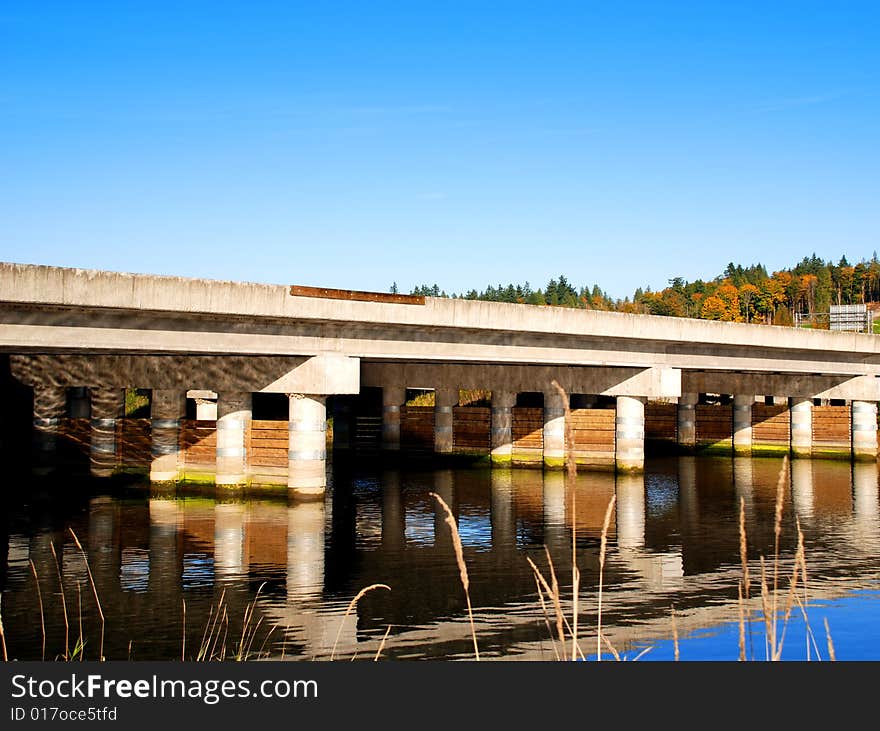 Highway Bridge over calm river. Highway Bridge over calm river