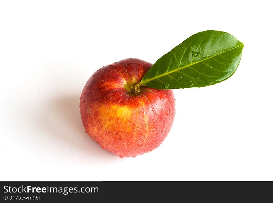 Bright isolated red apple with green leaf. Bright isolated red apple with green leaf