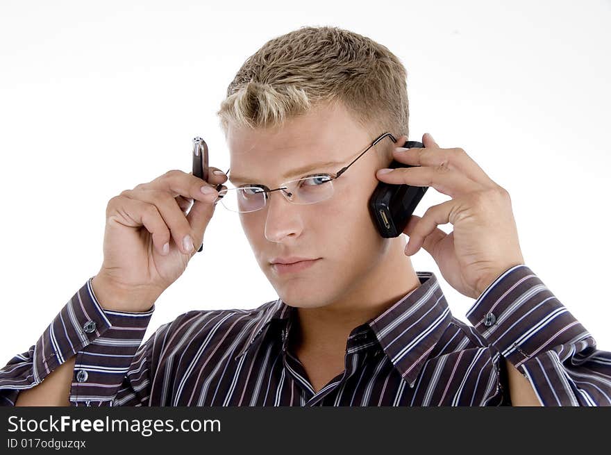 Serious businessman communicating on cell phone isolated with white background