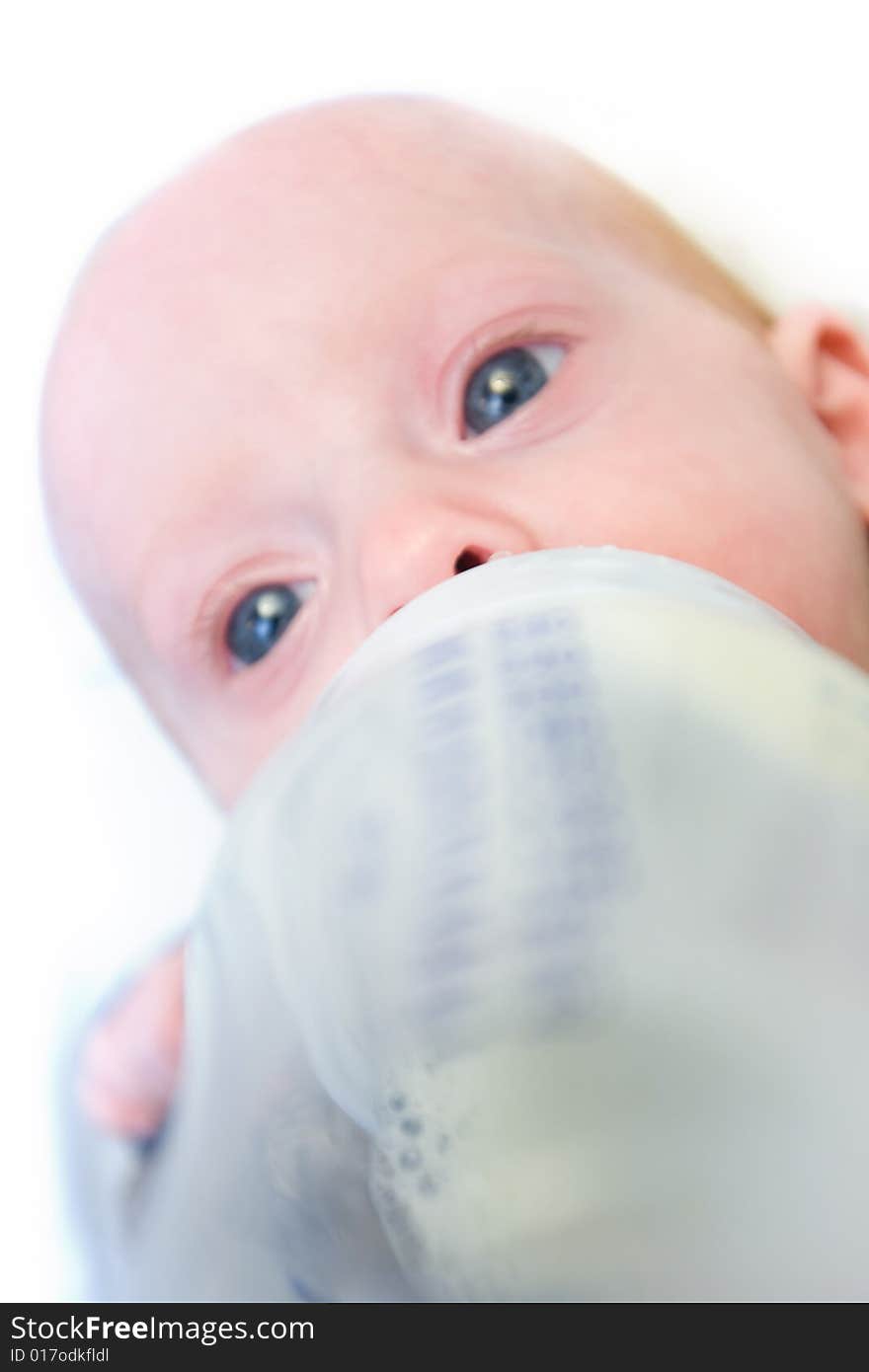 Newborn baby eating from  milk bottle