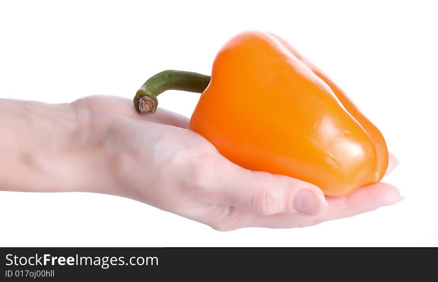 Orange pepper on hand isolated on white