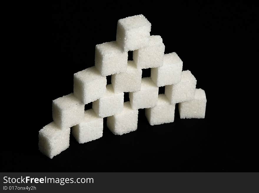 Sugar cubes isolated on black