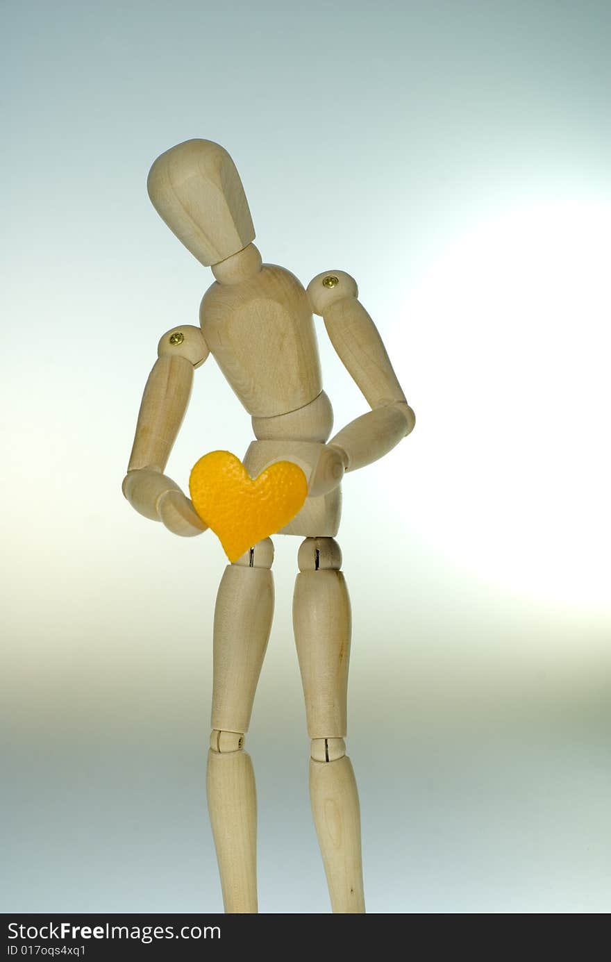 A shot of a jointed Doll showing a heart. A shot of a jointed Doll showing a heart