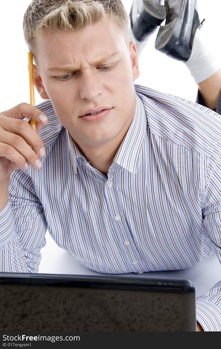 Thinking man with laptop and pencil on an isolated white background