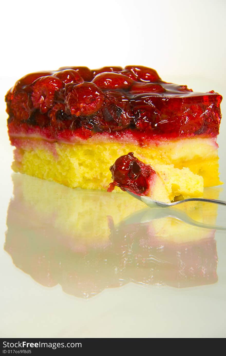 A shot of some rasberry tart and a spoon. A shot of some rasberry tart and a spoon