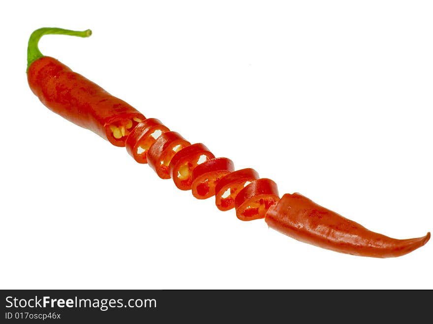 A shot of a sliced isolated chili on white. A shot of a sliced isolated chili on white