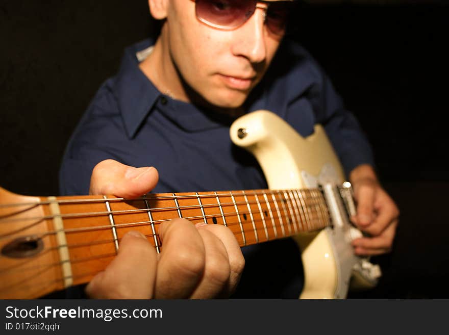 Portrait of a guitarist in concert.