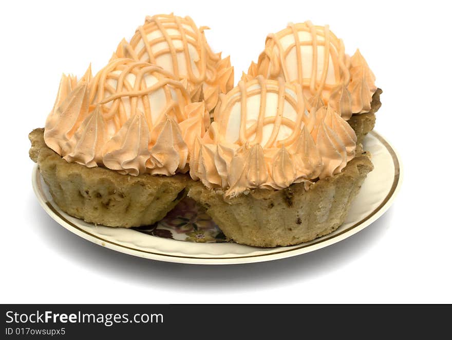 Four cake with a zephyr on a plate isolated on a white background