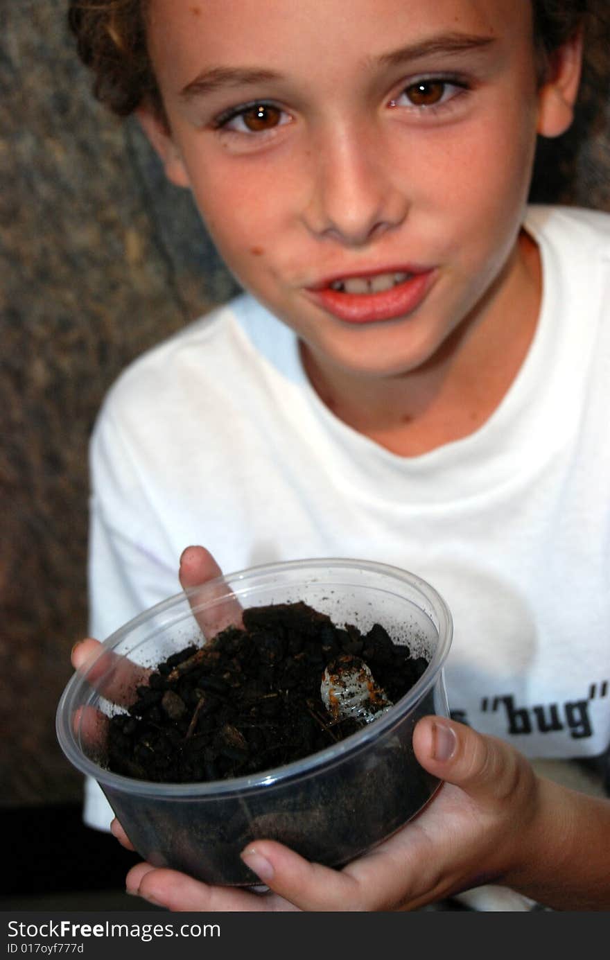 Boy with Chelorrhina polyphemus beetle grub