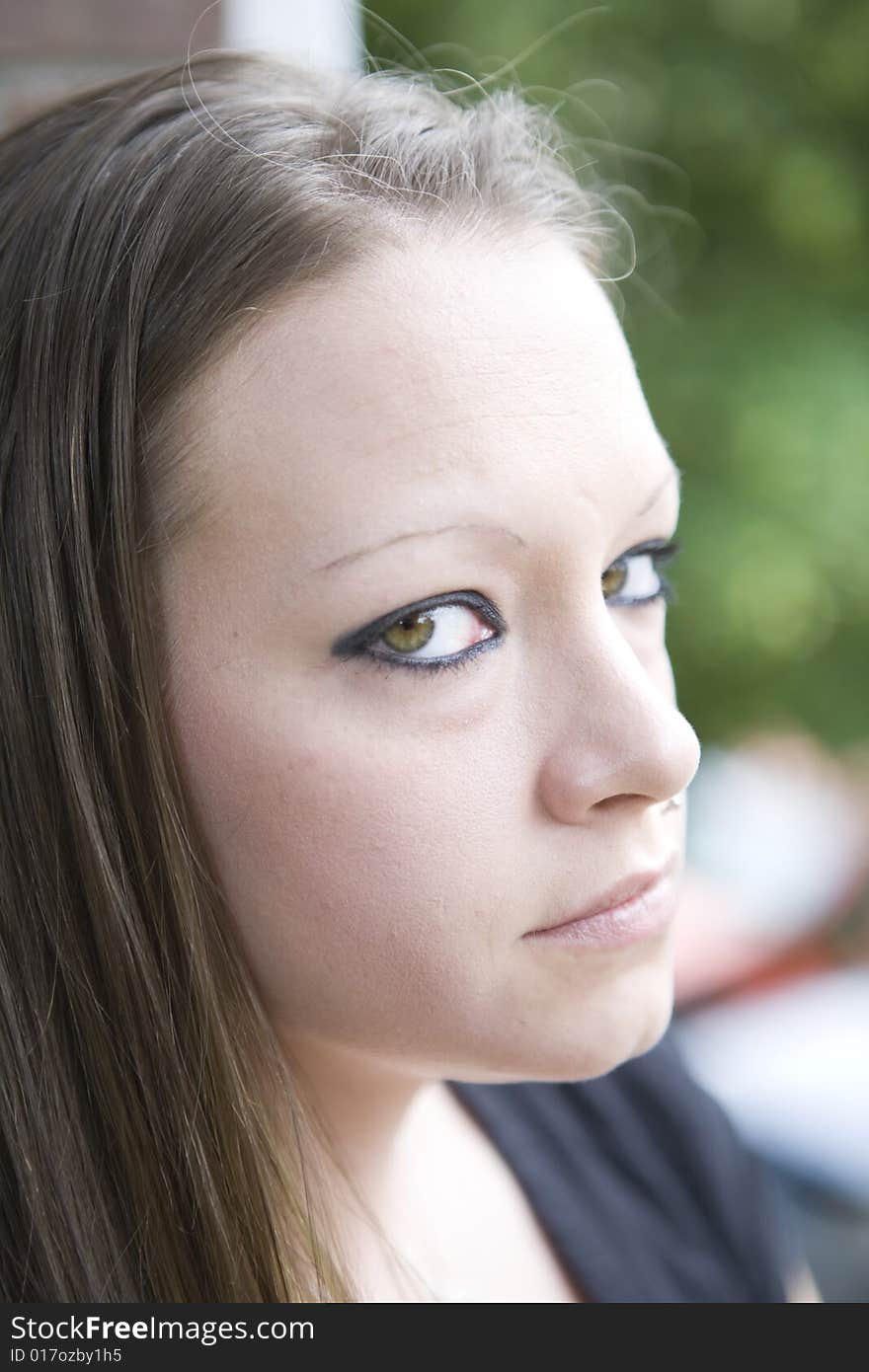 Young woman flashing a doubtful, questioning glance to the side. Young woman flashing a doubtful, questioning glance to the side