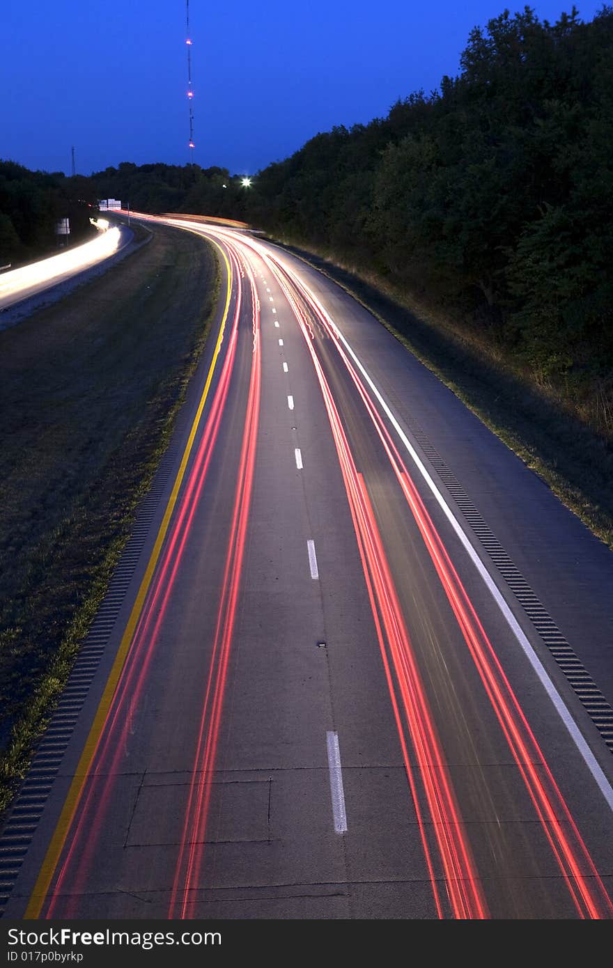 Streaking tail and head lights of automobiles on an interstate. Streaking tail and head lights of automobiles on an interstate.