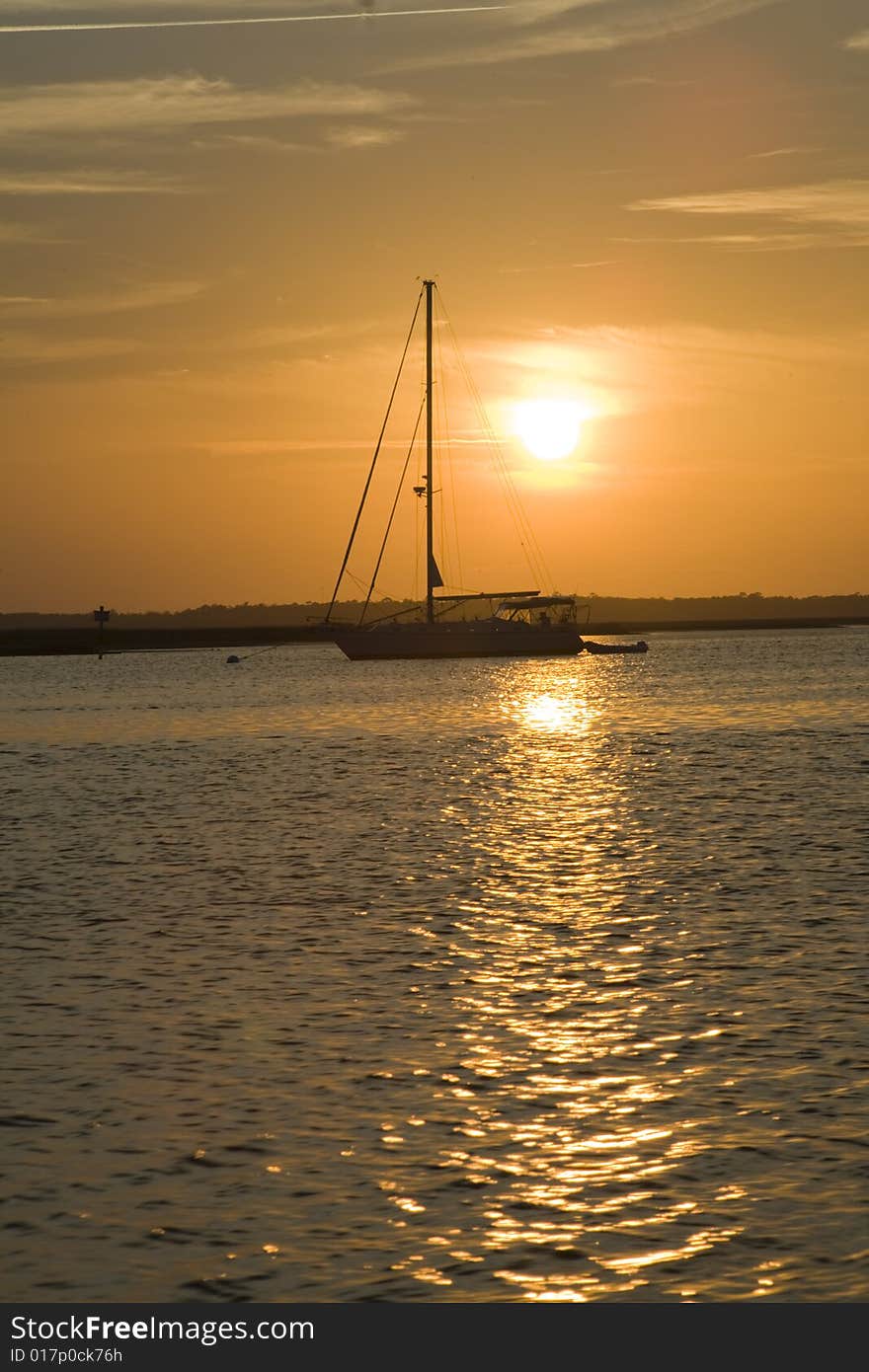 Sailboat at Sunset in coastal harbor