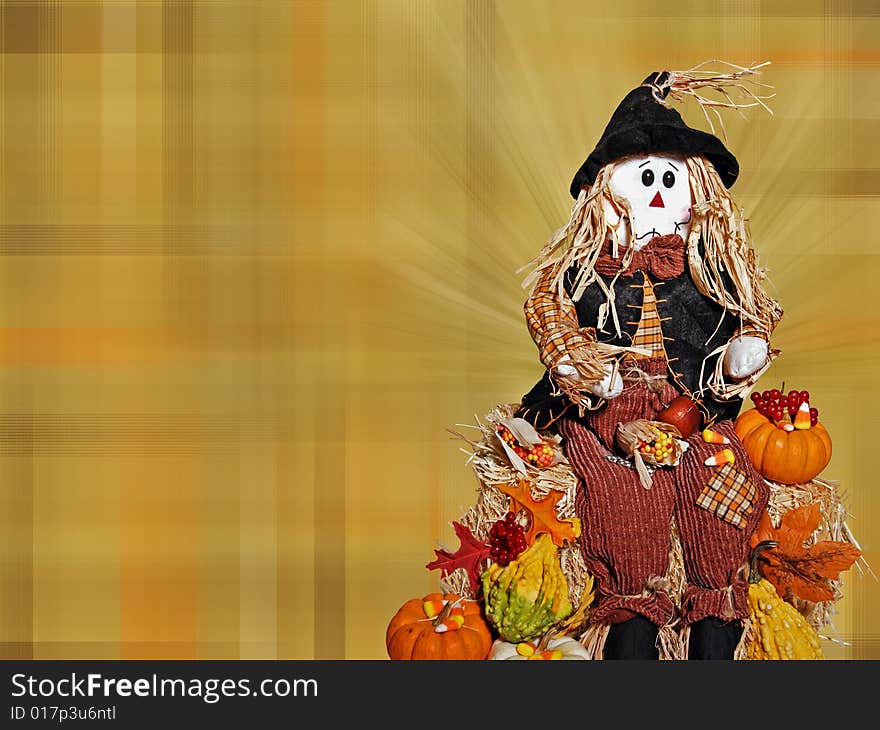 A scarecrow on a country hay bale with a plaid background. A scarecrow on a country hay bale with a plaid background.