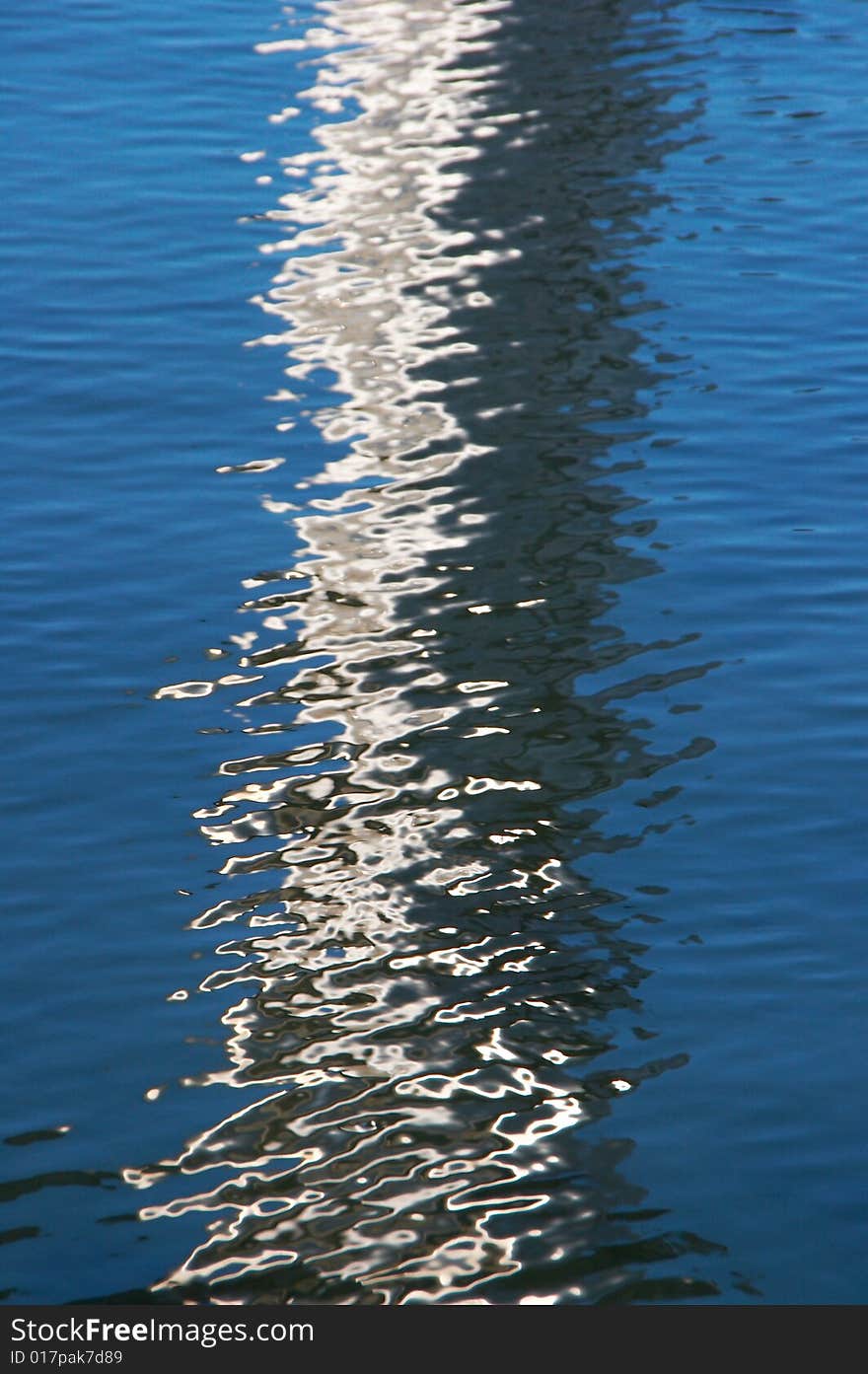 Textured rippled color water surface with  abstract reflection. Textured rippled color water surface with  abstract reflection