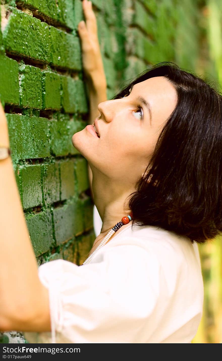 Woman Leans On Wall