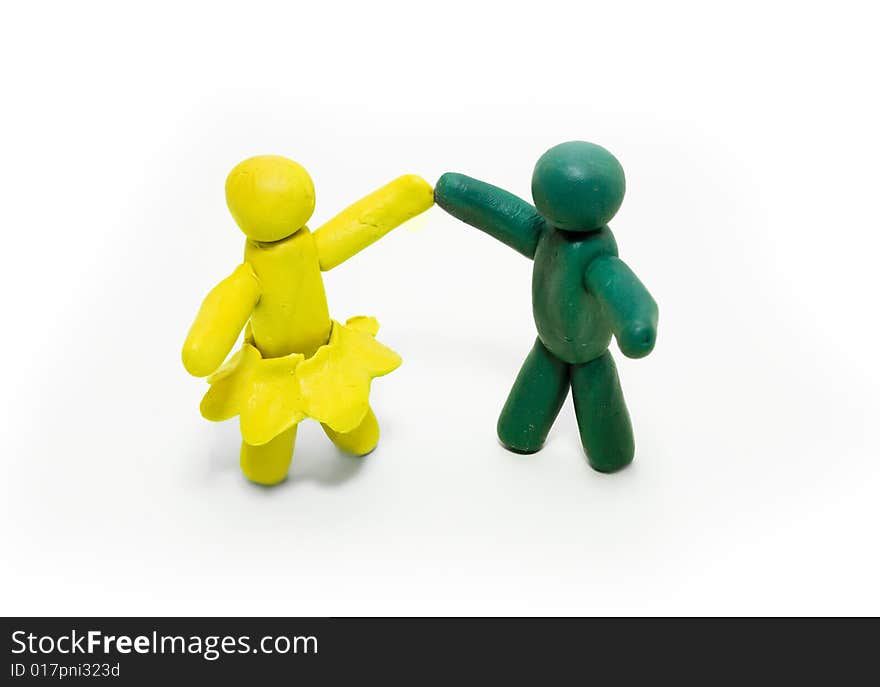 Two clay figures dancing on white background