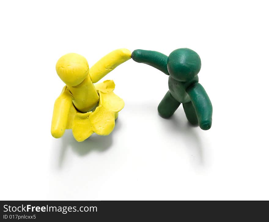 Two clay figures dancing on white background