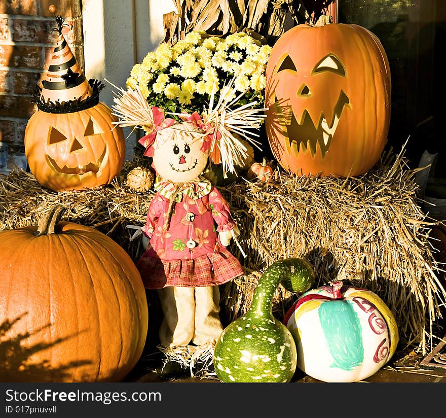 Scarecrow, pumpkins and gourds