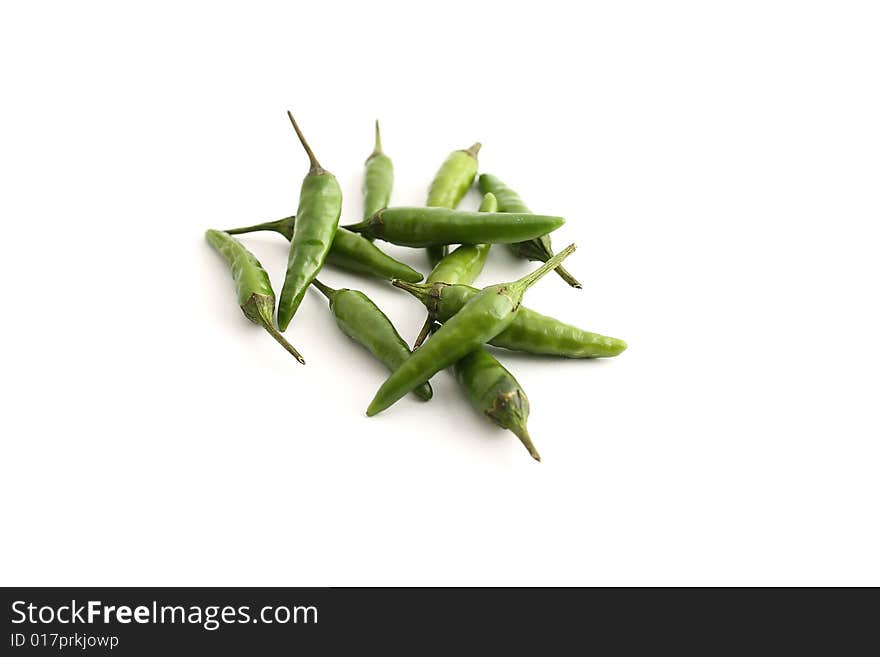 Green chilis on a white background